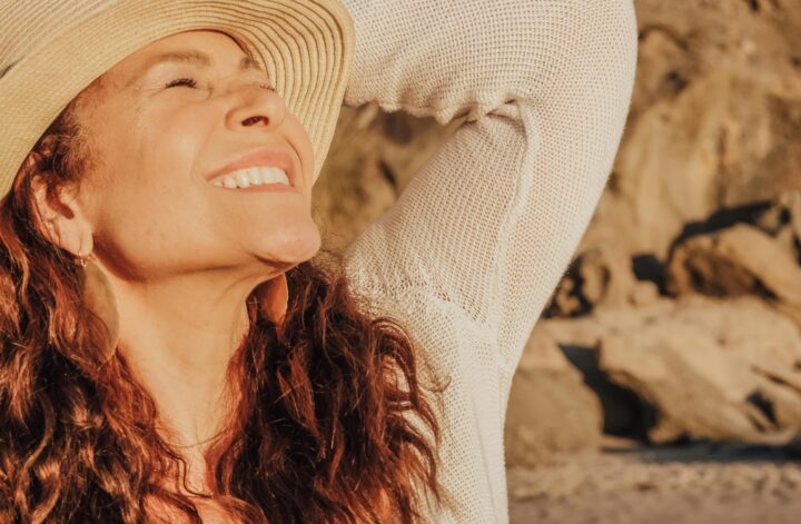 femme souriante avec un chapeau pleine d'énergie et de fatigue